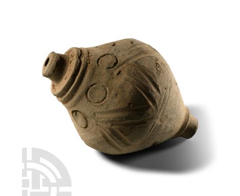 9th-11th century A.D. Piriform body with zigzag band to the equator and impressed roundels to the shoulder, tiered neck, dome