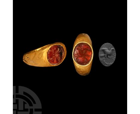 1st-2nd century A.D. and later. Hollow-formed finger ring with broad plaque; with a later gemstone of an eagle and snake with