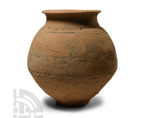 1st millennium B.C. With rounded profile, low foot and rounded everted rim to the mouth, painted horizontal bands to the shou
