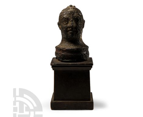 Roman, 1st-2nd century A.D. Modelled as a grotesque male head, depicted clean-shaven and hairless apart from a small tuft of 