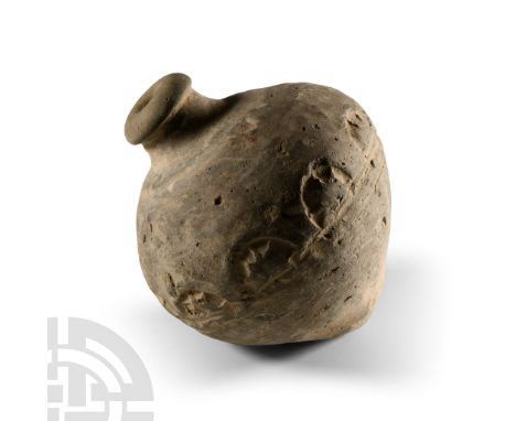 9th-11th century A.D. Piriform body with band of impressed rosettes to the equator, domed filler-hole, intended to be filled 