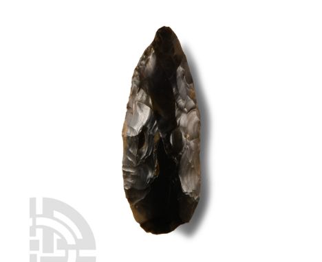 Neolithic Period, circa 7th-5th millennium B.C. Lentoid in section and ovoid in plan with some chipping to the rounded butt. 