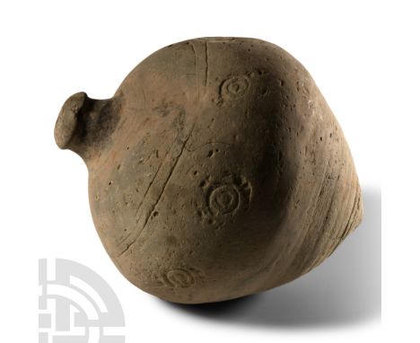 9th-11th century A.D. Piriform body with impressed roundels to the equator, domed filler-hole, intended to be filled with exp