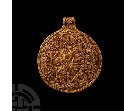 Circa 9th-11th century A.D. Disc with integral loop secured at the reverse; obverse with applied filigree and granulation for