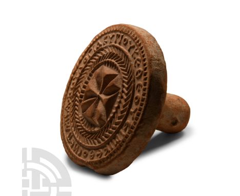 Circa 10th-11th century A.D. Discoid in plan with integral stub handle; central Maltese cross with herringbone ring and epigr