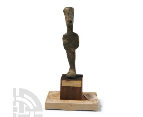 Circa 4th century B.C. Modelled with flat-section bdy, rounded head and feet, legs conjoined, impressed navel, carinated face
