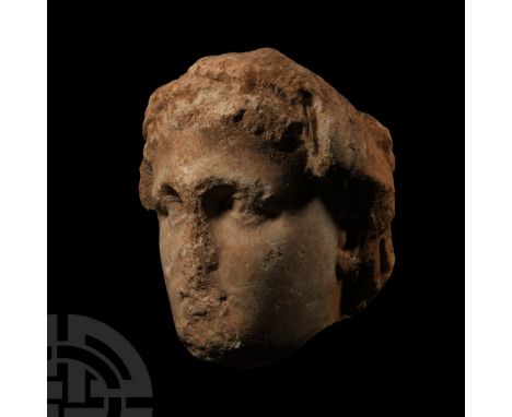 Hellenistic, 3rd-1st century B.C. Carved in the round with thick wreath of laurel leaves to the brow, short tousled hair, ste