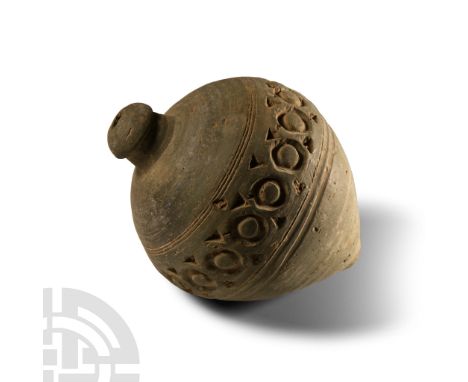 9th-11th century A.D. Piriform body with impressed ribs to the equator, band of roundels to the shoulder, domed filler-hole, 