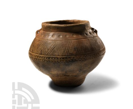Late Bronze Age II, 1400-1200 B.C. Biconvex in profile with dimpled base and broad mouth, band of linear chevron ornament to 