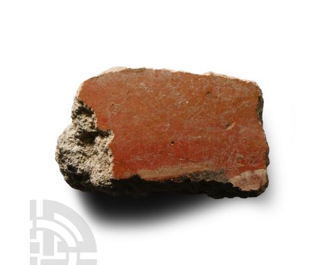 1st century A.D. Fragment of wall plaster with rendered surface painted red with yellow and white detailing to the edge; impr