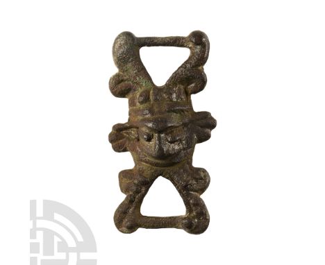 11th century A.D. Formed as a central plaque with forked arms above and below, each joined by a narrow bar; the arms with fle