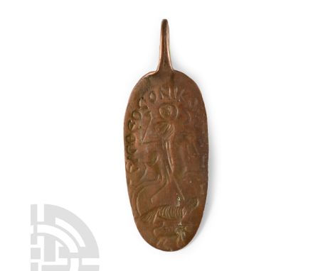 Circa 6th-8th century A.D. Tongue-shaped pendant with integral loop, obverse with stylised figure of a horseman spearing a cr