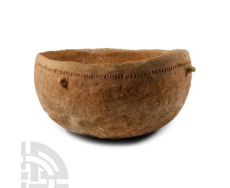Early Bronze Age I, 3rd millennium B.C. Of squat profile with rounded rim, two latera; stub handles and band of pointillé orn
