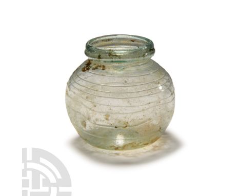 3rdt-4th century A.D. With dimpled base, bulbous body with opposed dimples to the sidewall, flange to the neck, applied trail