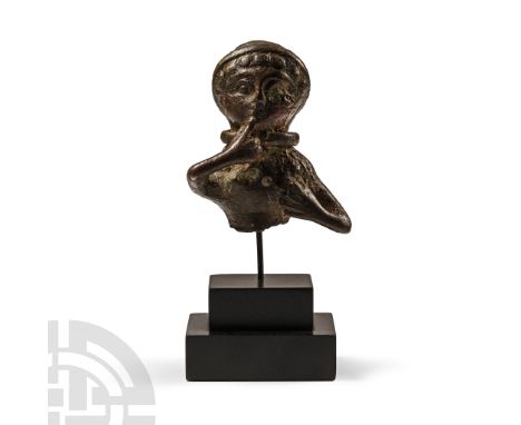 1st century B.C.-1st century A.D. Hollow-formed figurine fragment depicting a bare-chested female with a tight-fitting cap pl