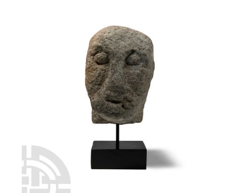Circa 2nd century B.C.-1st century A.D. or later. Sturdy carved stone head with almond-shaped face, incised disc eyes and slo