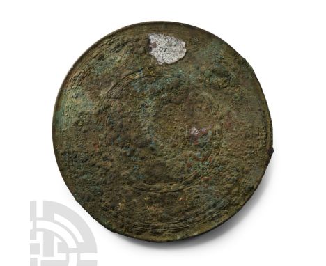 2nd century B.C.-2nd century A.D. Discoid with slightly raised rim to obverse, low-relief concentric ring detailing.  482 gra
