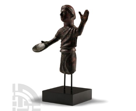 4th-3rd century B.C. Modelled in the round as a figure of a lar standing with the left hand raised with palm facing forwards,