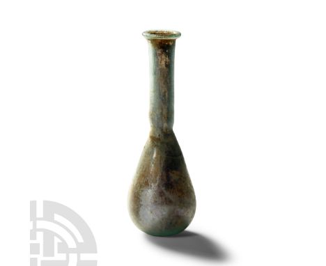 1st-2nd century A.D. With piriform body and flat base, narrow neck and everted rim. Cf. Whitehouse, D., Roman Glass in the Co