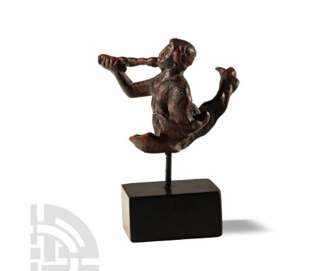 1st-2nd century A.D. Bare-chested with fish-tail extending to the rear, raising a periwinkle-shell horn to his lips; left arm