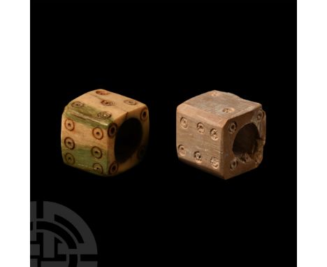 1st-4th century A.D. Each a cube with hollow centre and ring-and-dot markings disposed around the voids: 1:6, 2:5, 3:4 to voi