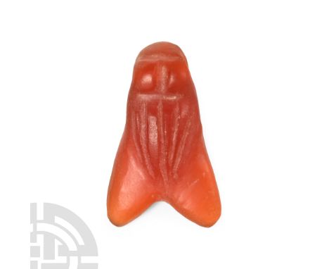 Late Period, 664-332 B.C. Carved with simple body and eye detailing and polished; drilled through the eyes for suspension. Cf