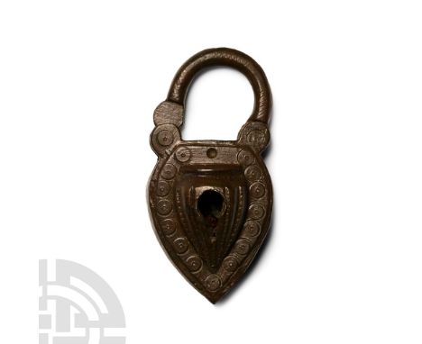 14th-16th century A.D. The body decorated with ring-and-dot motifs; the hinged, semi-circular hoop retained within the body o