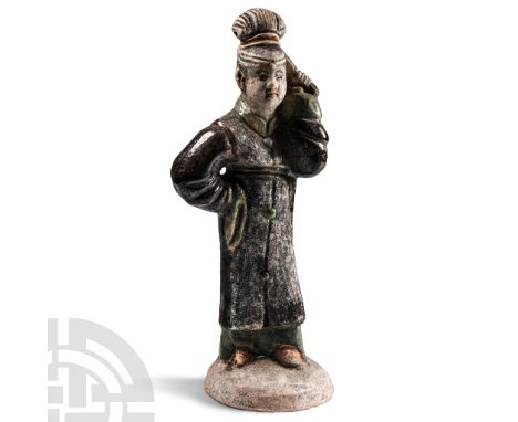 Qing Dynasty, 1644-1911 A.D. Hollow-formed ceramic figure of a lady holding a palmette fan to her head in her left hand, righ