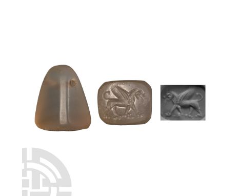 Neo Babylonian, 8th-6th century B.C. and later. Trapezoidal rock crystal seal pierced at the apex, with re-engraved intaglio 