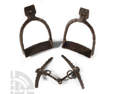 9th-11th century A.D. Comprising: two hand-forged iron stirrups each with a reinforcing strap beneath the footplate, slotted 
