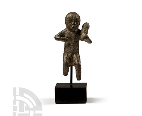 1st-2nd century A.D. Modelled in the round nude male with arms bent, the left arm supporting a bundle; discoid pad to the rum