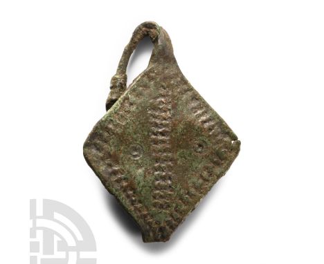 9th-11th century A.D. A slender shank with the ends twisted together, lozengiform plaque with punched ring-and-dot and bowtie