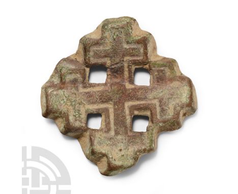 Circa 13th-14th century A.D. Formed as a cross-crosslet, the symbol of the Knights of the Holy Sepulchre, with punched-point 