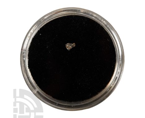 Found 14 April 2010 A.D. Mifflin meteorite crumb in a drum-shaped capsule.  0.005 grams, 2 mm (1/8 in.). Found in Wisconsin, 