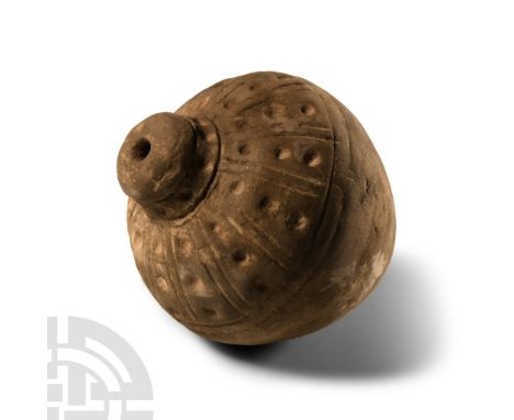9th-11th century A.D. Piriform body with segmented shoulder and impressed roundels, domed filler-hole, intended to be filled 