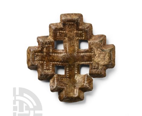 Circa 13th-14th century A.D. Formed as a cross-crosslet, the symbol of the Knights of the Holy Sepulchre, with punched-point 
