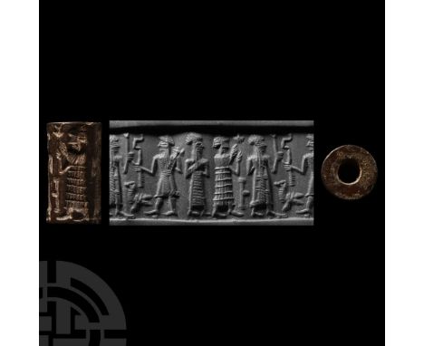 Circa 1900-1800 B.C. Haematite with four standing figures; accompanied by a section of an old typed scholarly note on a colle