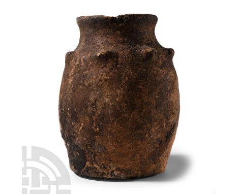 Early Bronze Age, 3rd-2nd millennium B.C. Barrel-shaped with slightly flared base, rounded rim, row of projecting lugs to the