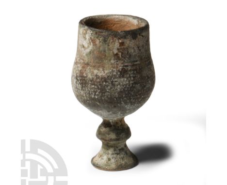 Roman, 4th century A.D. or later. Comprising a bulbous body with balustered stem and flared foot; band of pointillé ornament 