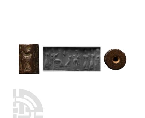 Circa 2nd millennium B.C. With frieze depicting a a seated figure holding a vessel in one extended hand, a star, a leaping do