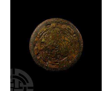 9th-10th century A.D. A discoid lead insular Scandinavian domed trade weight with inset boss; the copper-alloy bridle mount v