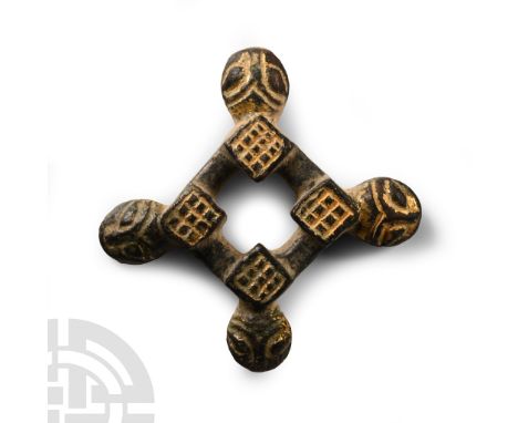Late 11th-13th century A.D. Featuring a cross-shaped central perforation, the internal corners with a raised chequered centre