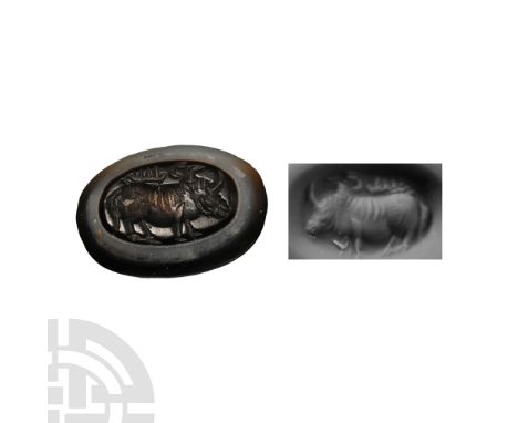Circa 400-600 A.D. Ellipsoid banded agate gemstone with intaglio standing bull, crescent above the shoulders; supplied with a