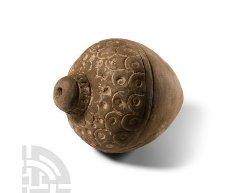 9th-11th century A.D. Piriform body with overlapping impressed roundels to the shoulder replicating scale armour, domed fille