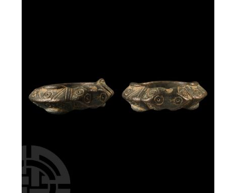 Circa 12th-13th century A.D. With a keeled hoop decorated with ring-and-dot and linear designs, the shoulders formed as styli