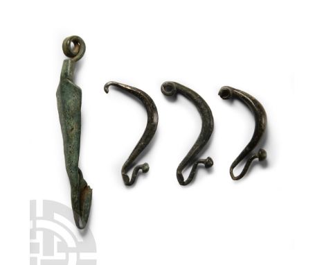 3rd century B.C. Comprising three bow brooches with conical finials; a brooch with an arrow-shaped plaque and coiled spring t