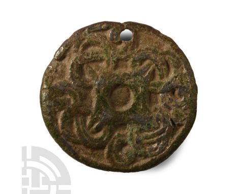 11th century A.D. Disc brooch with low-relief Borre style looped tendrils motif; catch broken and disc pierced for use as a p
