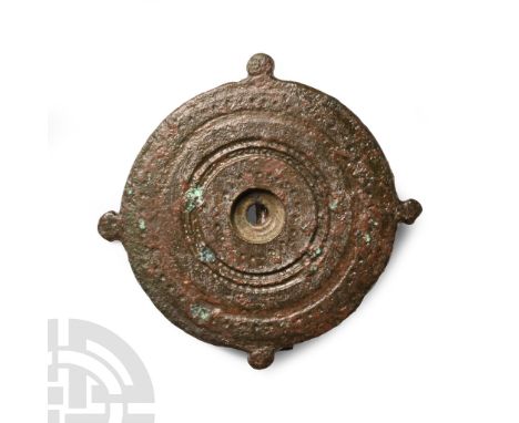 2nd century A.D. With concentric rings and punched detailing, radiating knops, pin, pin-lugs and catchplate to the reverse. C