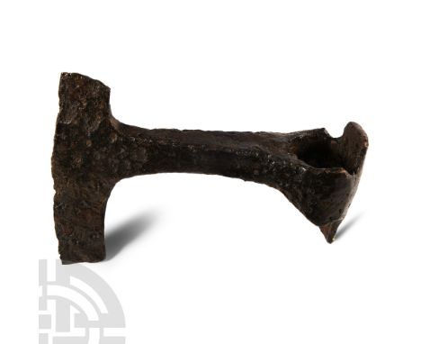 10th-12th century A.D. Narrow T-shaped blade with curved edge, large D-shaped socket with lateral triangular flanges and rect