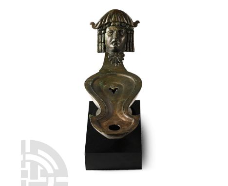 1st-2nd century A.D. With an elongated body and a long nozzle with a rounded tip; raised rim enclosing the upper face with an